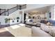 Spacious living room and open kitchen design with staircase offers modern living and entertaining at 225 Sundance Dr, Woodstock, GA 30188