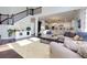 Open living room featuring a staircase, hardwood floors, and abundant natural light at 225 Sundance Dr, Woodstock, GA 30188