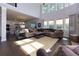 Bright living room boasts soaring ceilings and a large sectional sofa for comfortable Gathering living at 225 Sundance Dr, Woodstock, GA 30188