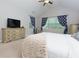 Cozy main bedroom with soft carpet, accent chair, dresser, and ample natural light at 225 Sundance Dr, Woodstock, GA 30188