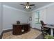 Dedicated office space featuring a large desk, chair, and natural light from the window at 225 Sundance Dr, Woodstock, GA 30188