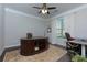 Office space with a large wooden desk and lots of natural light at 225 Sundance Dr, Woodstock, GA 30188