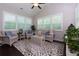Bright sunroom with large windows, wicker furniture, and modern decor at 225 Sundance Dr, Woodstock, GA 30188