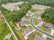 Aerial view of a community showcasing the layout of houses, roads and surrounding greenery at 2889 Windsor Knoll Dr, Dacula, GA 30019