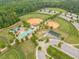 Aerial view showcasing baseball fields in a well-maintained park with trees and parking at 2889 Windsor Knoll Dr, Dacula, GA 30019