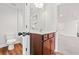 Bright bathroom featuring a vanity with a wooden cabinet and stylish fixtures with modern sink and mirror at 2889 Windsor Knoll Dr, Dacula, GA 30019