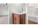 This bathroom features a wooden vanity with a bright sink with modern fixtures, a toilet and a bathtub at 2889 Windsor Knoll Dr, Dacula, GA 30019