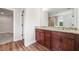 A well-lit bathroom features a double sink vanity with modern fixtures and dark wood cabinetry at 2889 Windsor Knoll Dr, Dacula, GA 30019