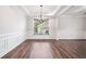 Elegant dining room featuring tray ceiling, wainscoting and wood flooring at 2889 Windsor Knoll Dr, Dacula, GA 30019
