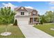 Traditional two-story home with a well-maintained lawn and a concrete driveway at 2889 Windsor Knoll Dr, Dacula, GA 30019