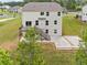 A beautiful aerial view showcasing a wooden deck, well-maintained lawn, and concrete patio with basketball hoop at 2889 Windsor Knoll Dr, Dacula, GA 30019