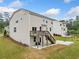 A beautiful view of the home showcasing a wooden deck, well-maintained lawn, and concrete patio with basketball hoop at 2889 Windsor Knoll Dr, Dacula, GA 30019
