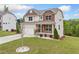 Charming two-story home featuring a covered front porch, well-manicured lawn, and inviting curb appeal at 2889 Windsor Knoll Dr, Dacula, GA 30019