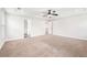 A spacious main bedroom features neutral carpet, a ceiling fan and many doorways at 2889 Windsor Knoll Dr, Dacula, GA 30019