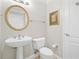 Bathroom boasts a pedestal sink, round mirror, and decorative lighting at 3475 Oak Valley Ne Rd # 950, Atlanta, GA 30326