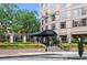 The Oaks at Buckhead building entrance with beautifully landscaped gardens and manicured hedges at 3475 Oak Valley Ne Rd # 950, Atlanta, GA 30326