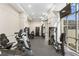 Bright gym space featuring stationary bikes and weight machines, with a large window view at 3475 Oak Valley Ne Rd # 950, Atlanta, GA 30326