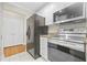 Well-lit kitchen features white cabinetry, granite counters, and stainless steel appliances at 3475 Oak Valley Ne Rd # 950, Atlanta, GA 30326