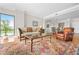 Bright living room with large windows, hardwood floors, and an ornate oriental rug and an adjacent dining room at 3475 Oak Valley Ne Rd # 950, Atlanta, GA 30326