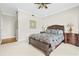 Spacious bedroom with a ceiling fan, nightstands, and carpet flooring at 3475 Oak Valley Ne Rd # 950, Atlanta, GA 30326