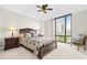 Bedroom featuring a large window with a city view, ceiling fan, and carpet flooring at 3475 Oak Valley Ne Rd # 950, Atlanta, GA 30326