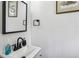 Elegant bathroom featuring a modern sink with matte black faucet, mirror and decorative hand soap at 1477 Spruce Se Dr, Smyrna, GA 30080