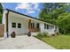 Inviting home featuring a well manicured lawn, beautiful flower beds, and a charming front porch at 1477 Spruce Se Dr, Smyrna, GA 30080