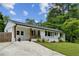 Renovated ranch-style home featuring a freshly painted white brick exterior and updated landscaping at 1477 Spruce Se Dr, Smyrna, GA 30080