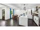 Bright kitchen and dining area with a quartz island, stainless appliances, and wood dining table with blue curtains at 1477 Spruce Se Dr, Smyrna, GA 30080