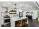 Modern kitchen featuring a large island with seating, stainless steel appliances, and stylish open shelving at 1477 Spruce Se Dr, Smyrna, GA 30080