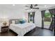 Comfortable main bedroom with a large bed, bedside tables, and windows offering a view of the backyard at 1477 Spruce Se Dr, Smyrna, GA 30080