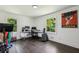 Bright office featuring hardwood floors, two windows, modern desk, and unique Cheers artwork at 1477 Spruce Se Dr, Smyrna, GA 30080