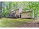 Angled exterior view of home with back porch, siding and lush backyard with foliage at 205 N Fayette Dr, Fayetteville, GA 30214