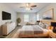 Staged bedroom showcasing a neutral palette, natural light, and a ceiling fan at 205 N Fayette Dr, Fayetteville, GA 30214