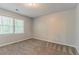 An empty bedroom with neutral carpet, neutral walls, and a window for natural light at 205 N Fayette Dr, Fayetteville, GA 30214