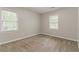 Bright bedroom featuring two large windows, carpet flooring, and neutral wall paint at 205 N Fayette Dr, Fayetteville, GA 30214
