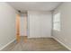 An empty bedroom features a closet with sliding doors and neutral-colored walls at 205 N Fayette Dr, Fayetteville, GA 30214