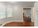 Dining area with hardwood floors, window, and view into living room and hallway at 205 N Fayette Dr, Fayetteville, GA 30214