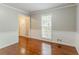 Dining room featuring wainscoting, hardwood floors, and an adjacent doorway and large window at 205 N Fayette Dr, Fayetteville, GA 30214