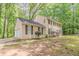 Side view of two-story home with attached garage and mature trees in a residential area at 205 N Fayette Dr, Fayetteville, GA 30214