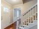 View of foyer with hardwood floors, white trim, and staircase with view to front door at 205 N Fayette Dr, Fayetteville, GA 30214