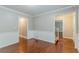 Hallway featuring fresh paint and trim, and hardwood floors, with visibility into other rooms at 205 N Fayette Dr, Fayetteville, GA 30214