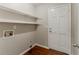 Laundry room with shelves, hookups, door to outside, and hardwood floor at 205 N Fayette Dr, Fayetteville, GA 30214