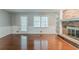 Inviting living room featuring a brick fireplace, built-in shelving, and beautiful hardwood floors at 205 N Fayette Dr, Fayetteville, GA 30214