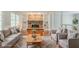 This living room showcases a brick fireplace flanked by built-in shelving and comfortable seating at 205 N Fayette Dr, Fayetteville, GA 30214