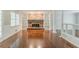 Living room boasts a brick fireplace with built-in bookshelves, hardwood floors, and ample natural light at 205 N Fayette Dr, Fayetteville, GA 30214