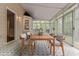 Staged view of screened in porch with black and white tile and furniture set at 205 N Fayette Dr, Fayetteville, GA 30214