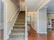 Carpeted stairway featuring white railings, hardwood floors, and neutral paint tones at 205 N Fayette Dr, Fayetteville, GA 30214