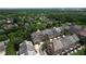 Aerial view of homes surrounded by lush greenery with the city skyline in the distance at 2295 Falmouth Se Ct, Smyrna, GA 30080