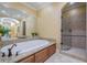 Elegant bathroom featuring a soaking tub, glass enclosed shower and double vanity at 2295 Falmouth Se Ct, Smyrna, GA 30080